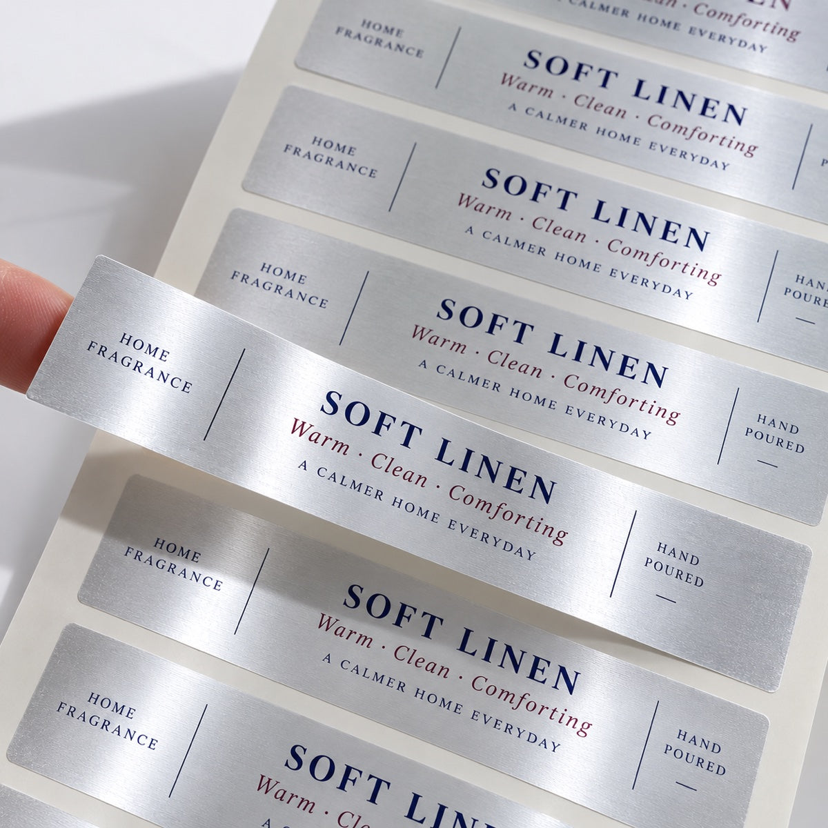 Custom metallic silver paper sticker sample showing shiny silver paper surface and print detail