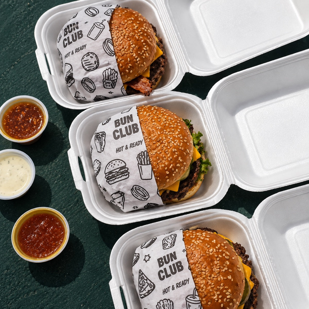 Custom printed food wrapping paper used with burger takeout boxes for branded restaurant packaging