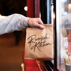 Custom kraft paper food bags with full color printed branding for bakery and takeout packaging