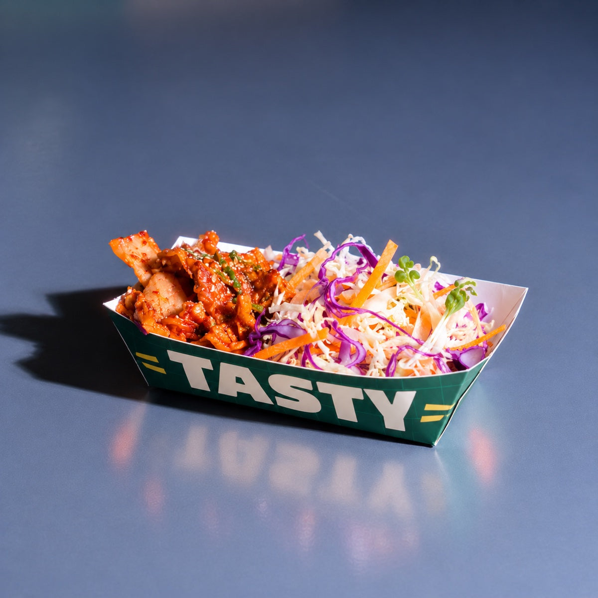 Custom printed paper food tray sample showing folded tray construction and logo print detail