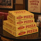 Custom printed pizza box sample showing stacked paperboard boxes and logo print detail