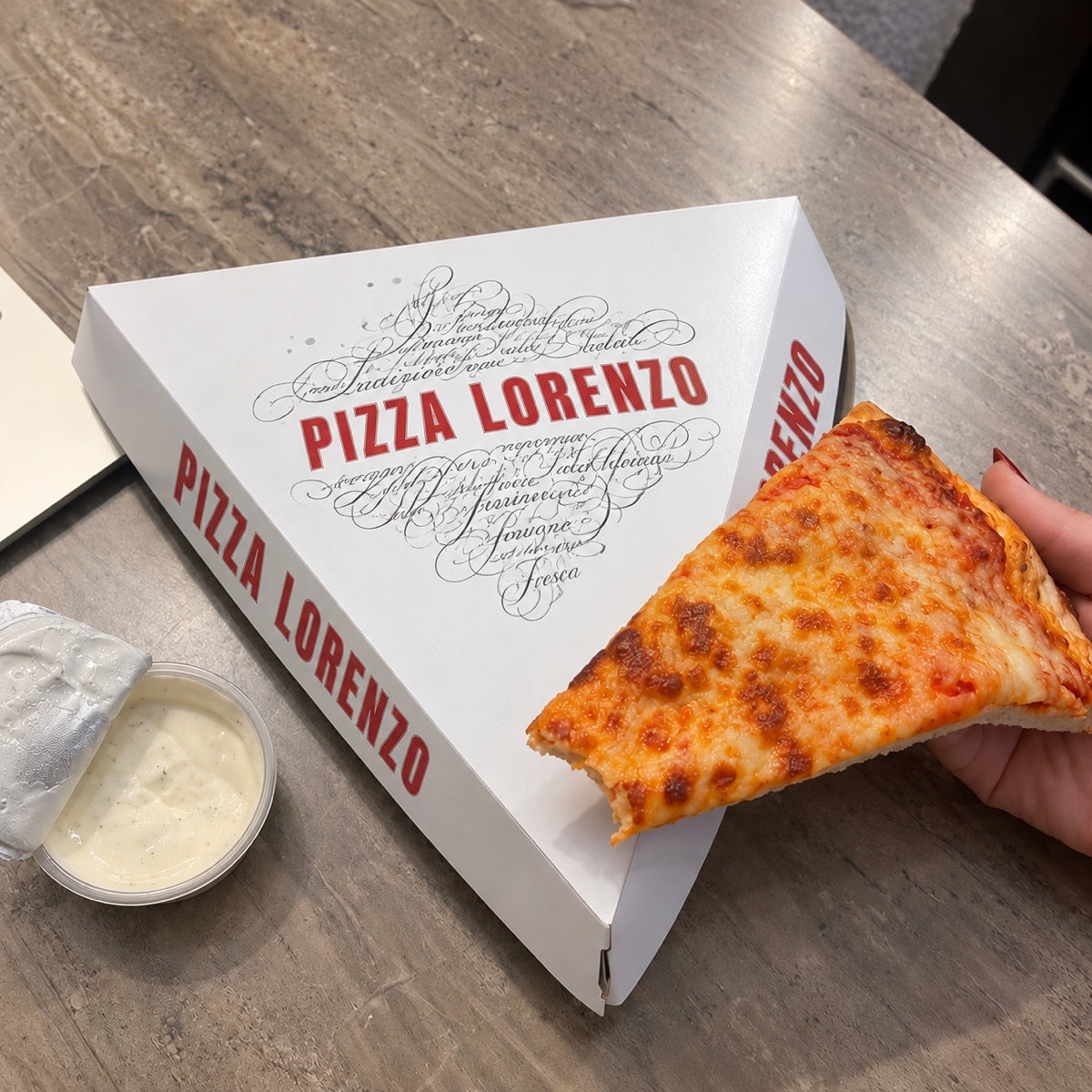 Custom printed pizza slice box sample showing triangular paperboard construction and logo print detail