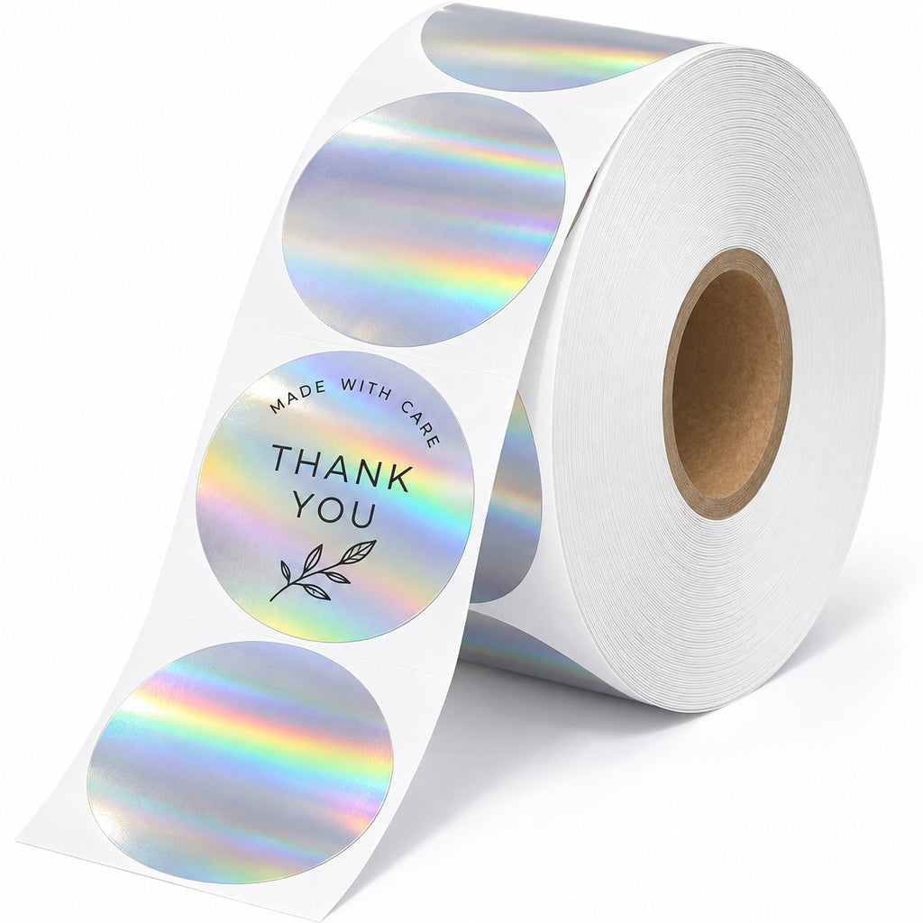 Roll of custom round holographic thank-you stickers with rainbow silver foil and black botanical printing.