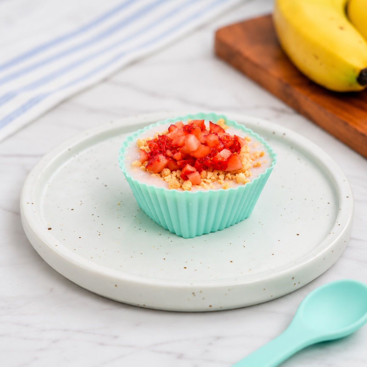 Reusable silicone dessert cup sample with strawberry crumble tartlet on a serving plate